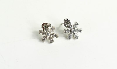Lot 118 - A pair of silver and diamond snowflake form...