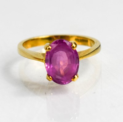 Lot 59 - An 18ct gold pink sapphire solitaire dress...