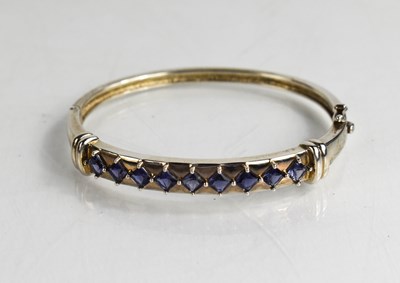 Lot 38 - A Q.V.C. tanzanite and silver bangle of nine...