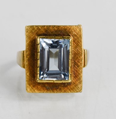 Lot 67 - A 14ct gold and emerald cut aquamarine dress...