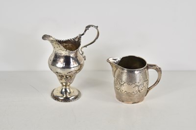 Lot 32 - A George III silver cream jug, embossed with...