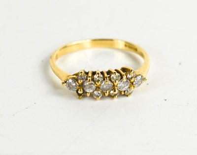 Lot 146 - An 18ct gold and diamond cluster ring, set...