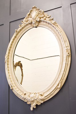Lot 386 - A reproduction white painted oval wall mirror...