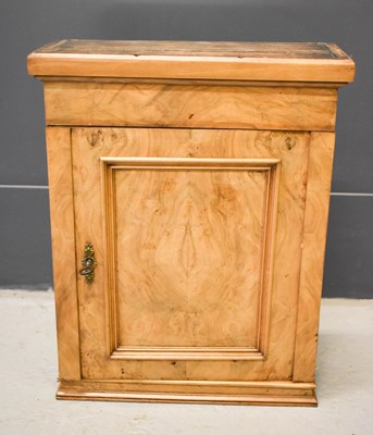 Lot 524 - A walnut wall cabinet with single door and...