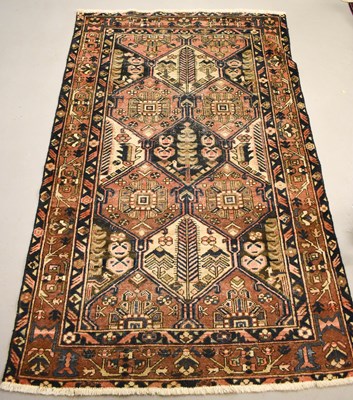 Lot 490 - A Middle Eastern woollen rug with dark blue...