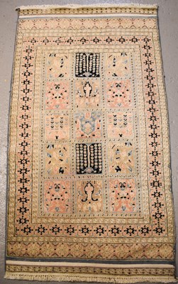 Lot 473 - A cream ground Middle Eastern wool rug with...