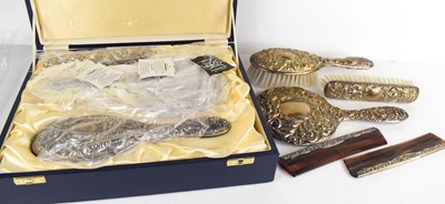 Lot 104 - A silver clad and embossed dressing table set...
