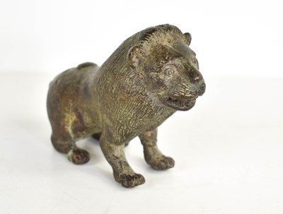 Lot 260 - An early bronze lion, with areas of green...