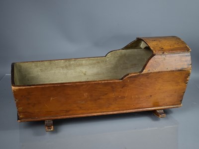 Lot 321 - An antique dolls cradle, in stained pine,...