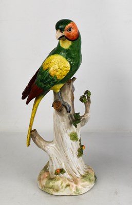 Lot 207 - A German porcelain parrot perched on a tree...