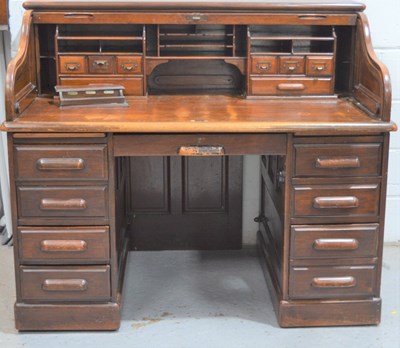 Lot 559 - An early 20th century oak roll top writing...
