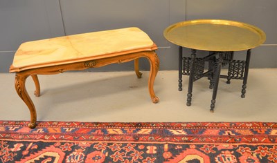 Lot 525 - A Middle Eastern brass tray top table with...