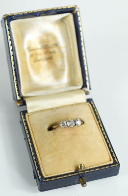 Lot 198 - A gold and diamond three stone ring, the...