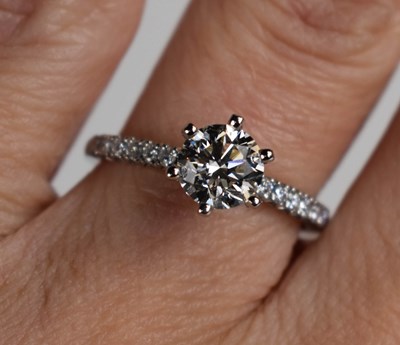 Lot 11 - A platinum and diamond solitaire ring, the...