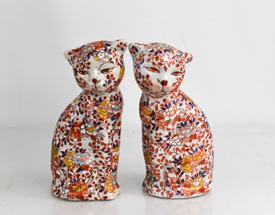 Lot 397 - A pair of Chinese polychrome enamelled cats,...