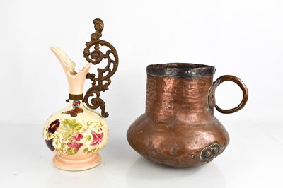 Lot 203 - An antique copper jug with hoop handle,...