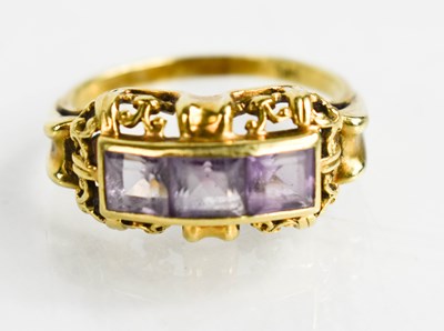 Lot 37 - A 14ct gold and amethyst three stone ring in...