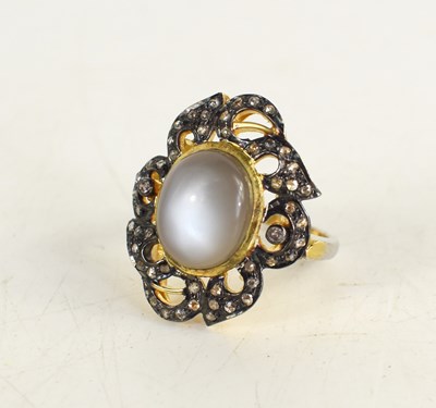 Lot 235 - A silver gilt oval cabochon moonstone and rose-...