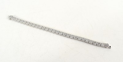 Lot 11 - A 14ct white gold diamond cluster line...