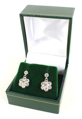 Lot 274 - A pair of 18ct white gold daisy-style diamond...
