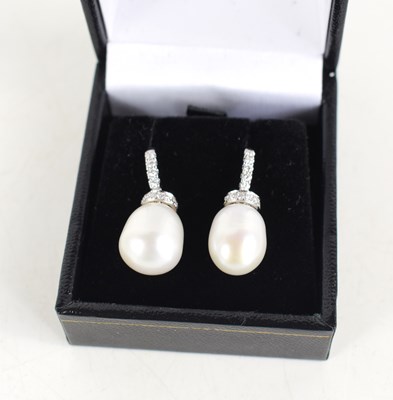 Lot 265 - A pair of 18ct white gold droplet earrings set...