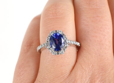Lot 281 - An 18ct white gold oval sapphire and diamond...