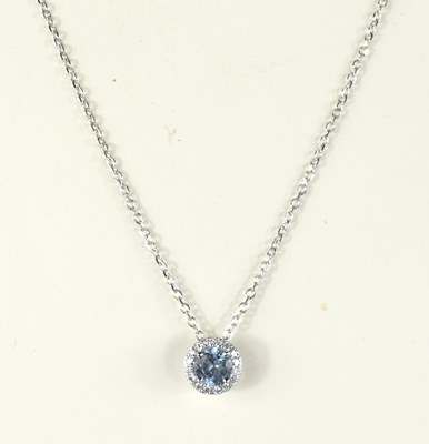 Lot 247 - An 18ct white gold round aquamarine and...