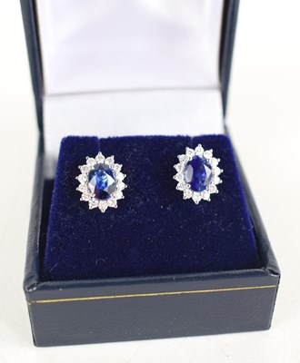 Lot 270 - A pair of 18ct white gold oval sapphire and...