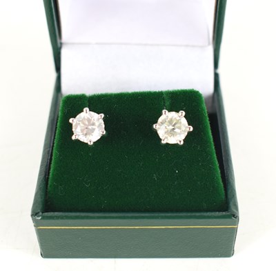 Lot 282 - A pair of platinum screw back 6-claw set...