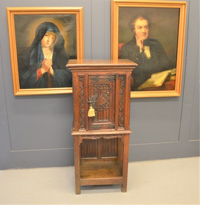 Lot 583 - A Gothic revival oak cabinet the single door...
