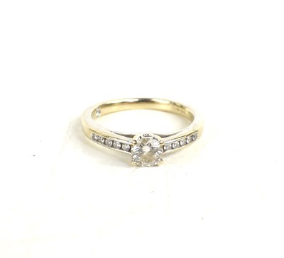 Lot 232 - An 18ct gold and diamond ring, the brilliant...