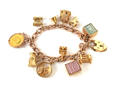 Lot 267 - A 9ct gold charm bracelet, the oval chain...