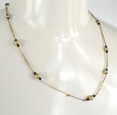 Lot 104 - A 9ct gold and pearl and black beaded necklace,...