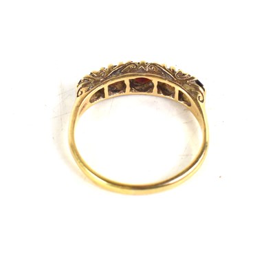 Lot 32 - A 9ct gold and garnet ring, the five graduated...