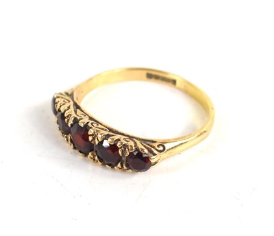 Lot 32 - A 9ct gold and garnet ring, the five graduated...