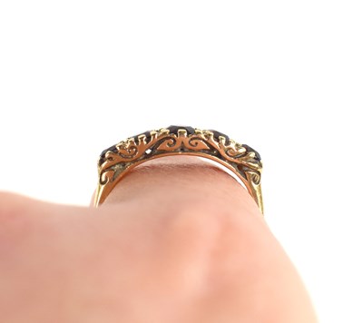 Lot 32 - A 9ct gold and garnet ring, the five graduated...