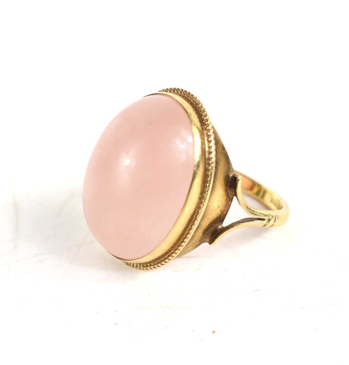 Lot 43 - A 9ct gold and rose quartz cabochon dress ring,...