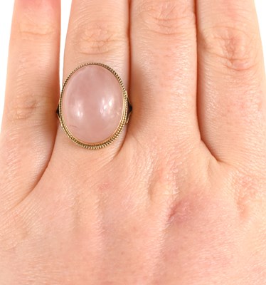 Lot 43 - A 9ct gold and rose quartz cabochon dress ring,...
