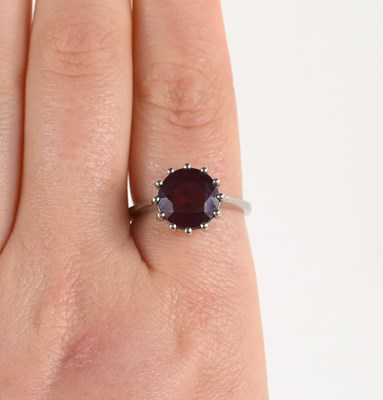 Lot 20 - A 14ct white gold and garnet ring, the...