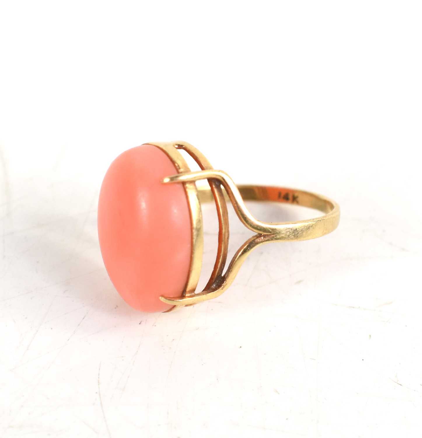 Lot 44 - A 14ct gold and coral cabochon set ring, size...