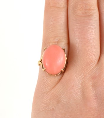 Lot 44 - A 14ct gold and coral cabochon set ring, size...