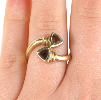 Lot 27 - A 9ct gold and smoky quartz cross over ring,...