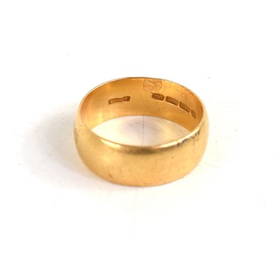 Lot 36 - An 18ct gold wedding band, planished finish,...