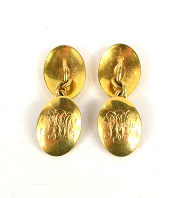Lot 239 - An 18ct gold pair of oval cufflinks, engraved...
