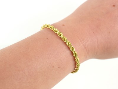 Lot 78 - A 9ct gold ropetwist bracelet, with a hoop...