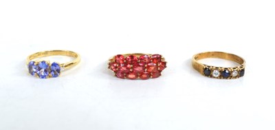 Lot 205 - A 10ct gold and tanzanite three stone ring,...