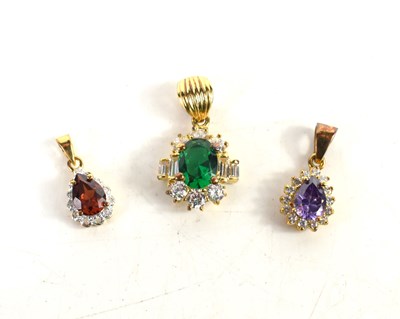 Lot 157 - Three 14ct gold pendants, one set with emerald...