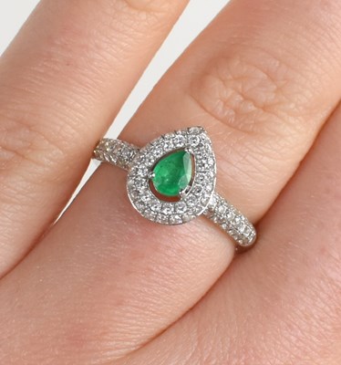 Lot 246 - An 18ct white gold, emerald and diamond ring,...