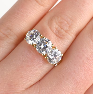 Lot 200 - A 14ct gold and cubic zircon three stone ring,...