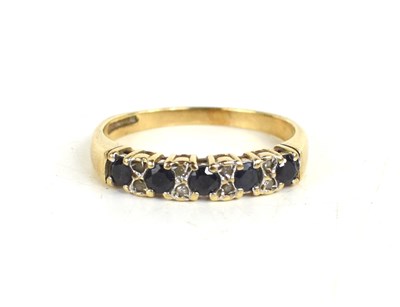 Lot 9 - A 9ct gold, diamond and sapphire ring, the...